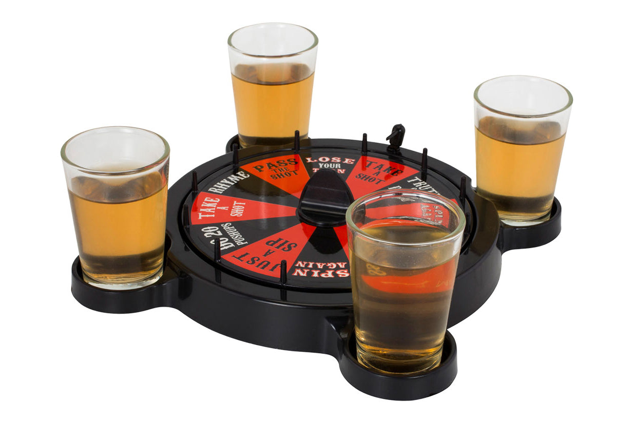 Drinking game set with four shot glasses and a spinner on a white background