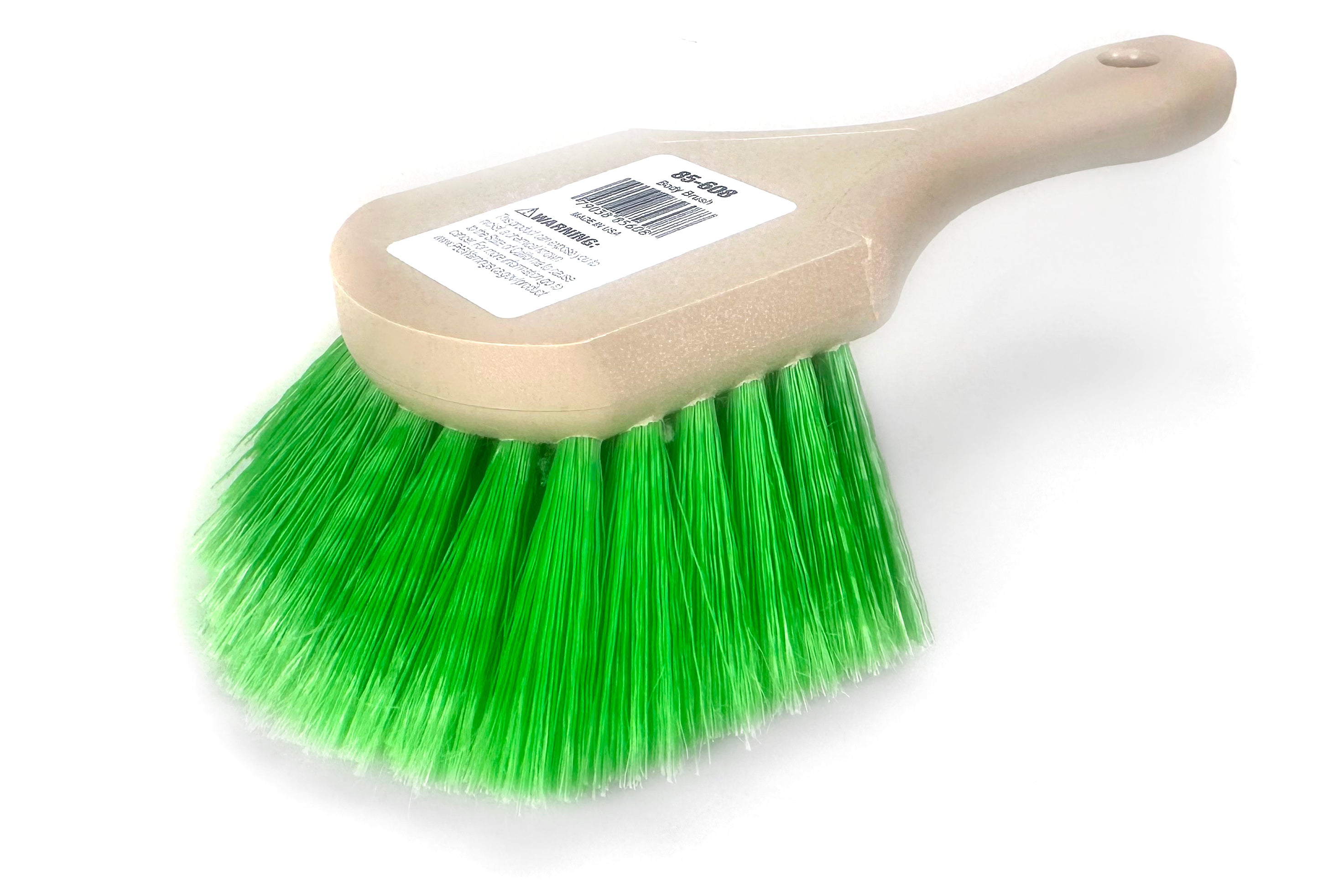 Cleaning brush with green bristles and beige handle on a white background