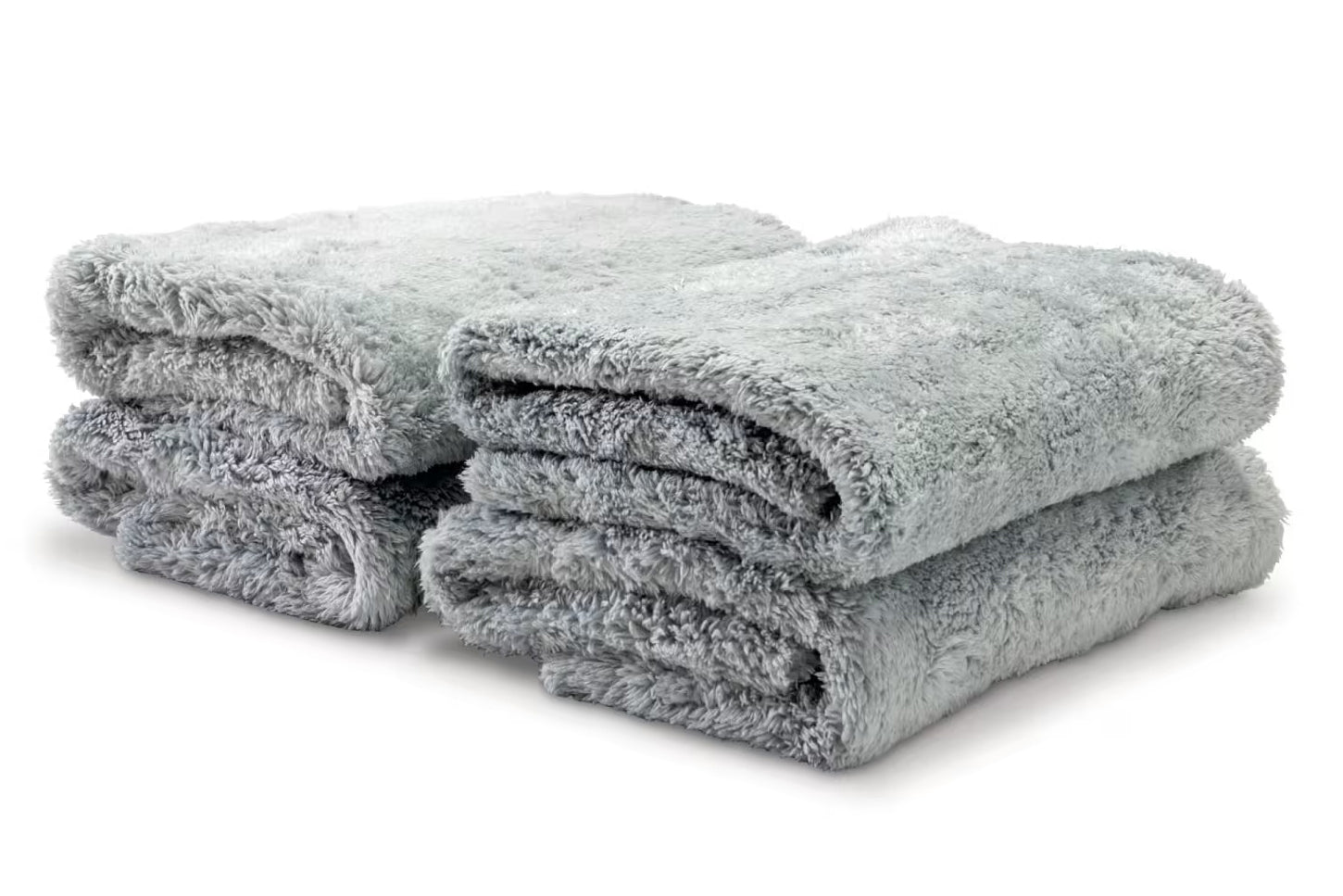 Stack of folded gray towels on a white background