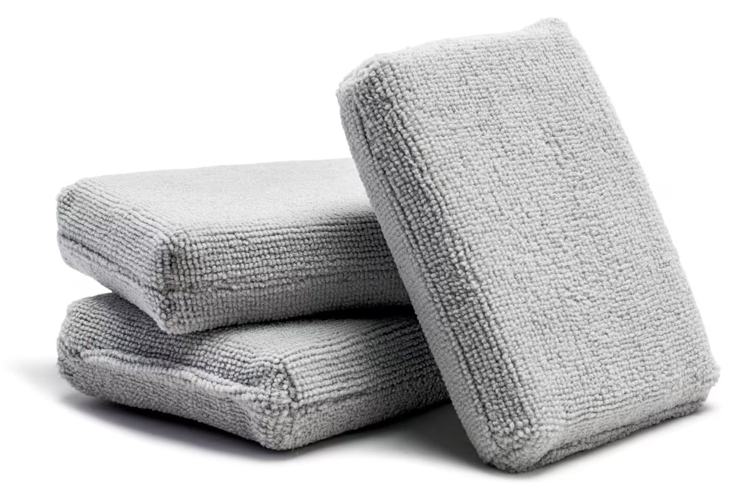 Three gray microfiber cloths stacked on a white background