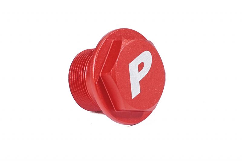 Red clutch delay valve delete plug with a hexagonal shape and a white "P" logo on the top.