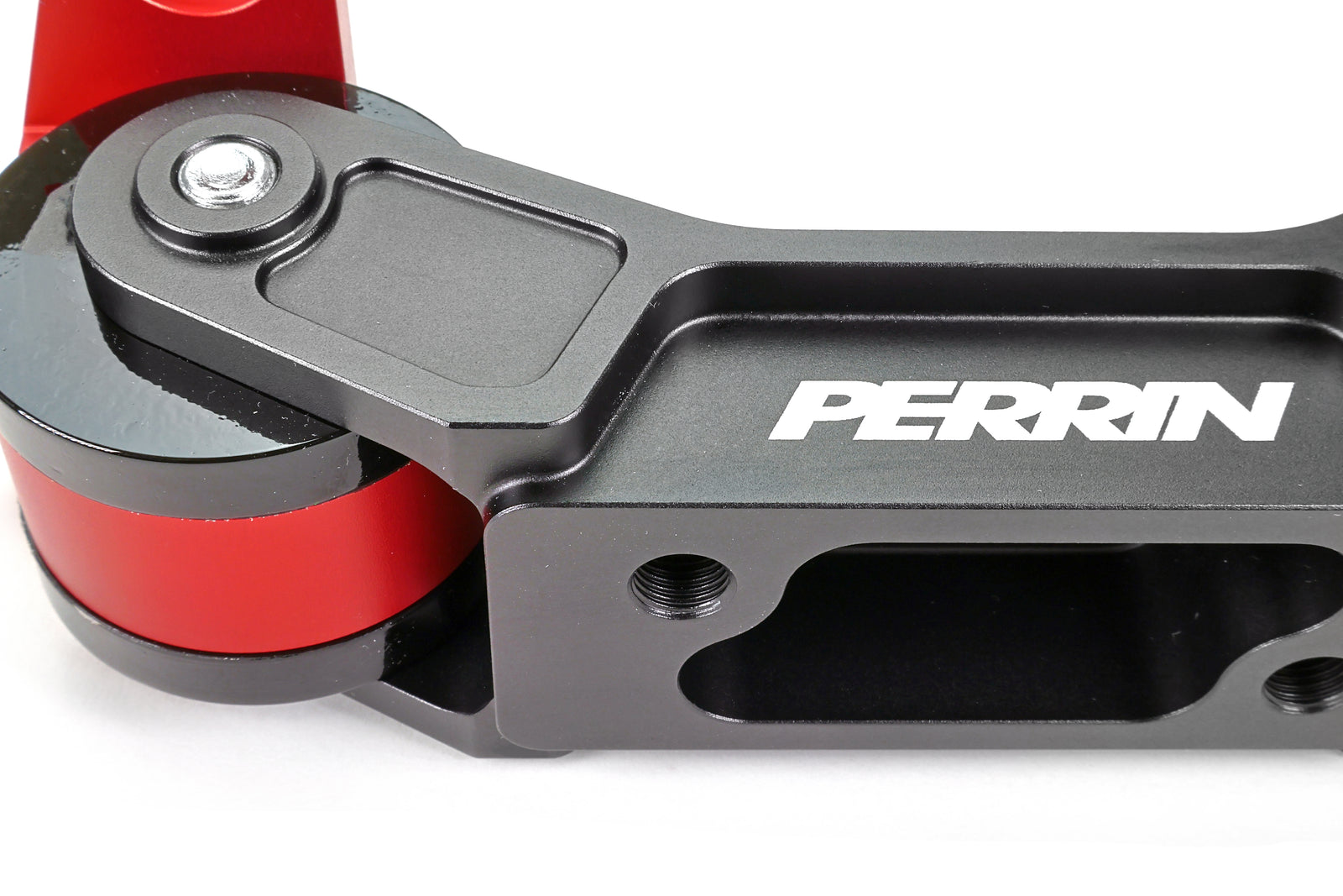 PERRIN Transmission Mount in black billet aluminum with red anodized mounting bases and black bushings