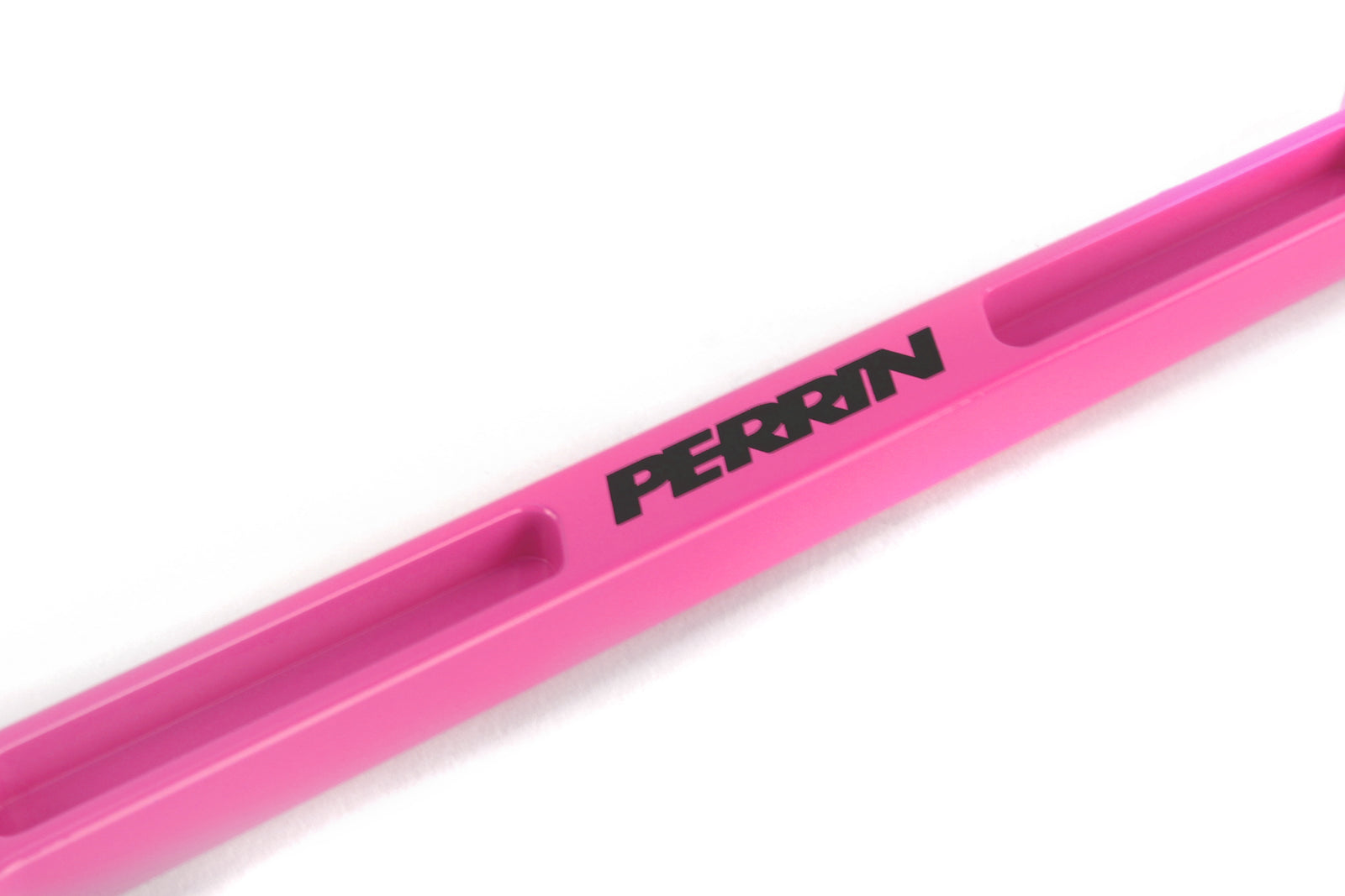 Perrin battery tie down in pink, designed for secure battery mounting in performance vehicles.