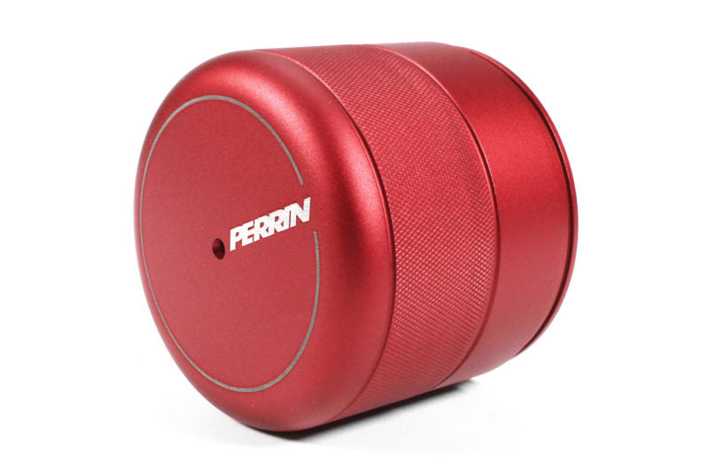 Red aluminum oil filter cover with a textured grip and Perrin branding, designed for enhanced engine performance.