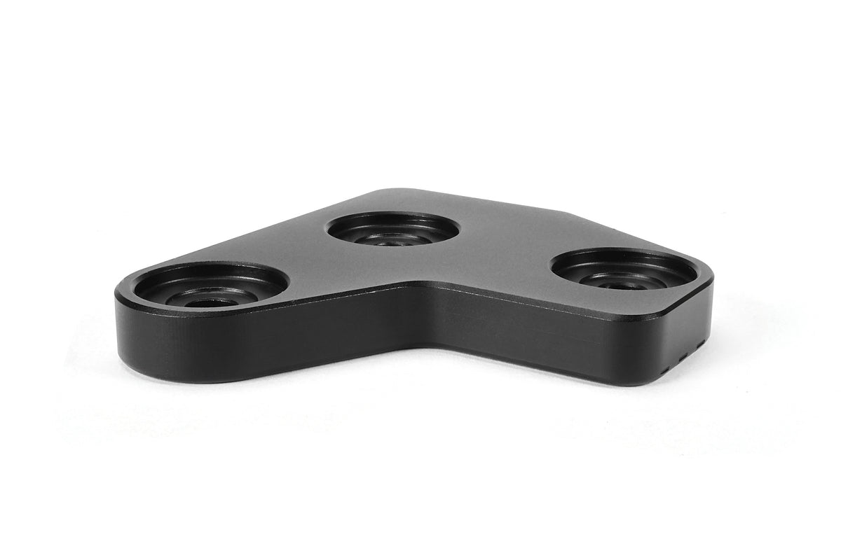 PERRIN GR Corolla Shifter Cable Bracket Lockdown with a black anodized finish on a white background.