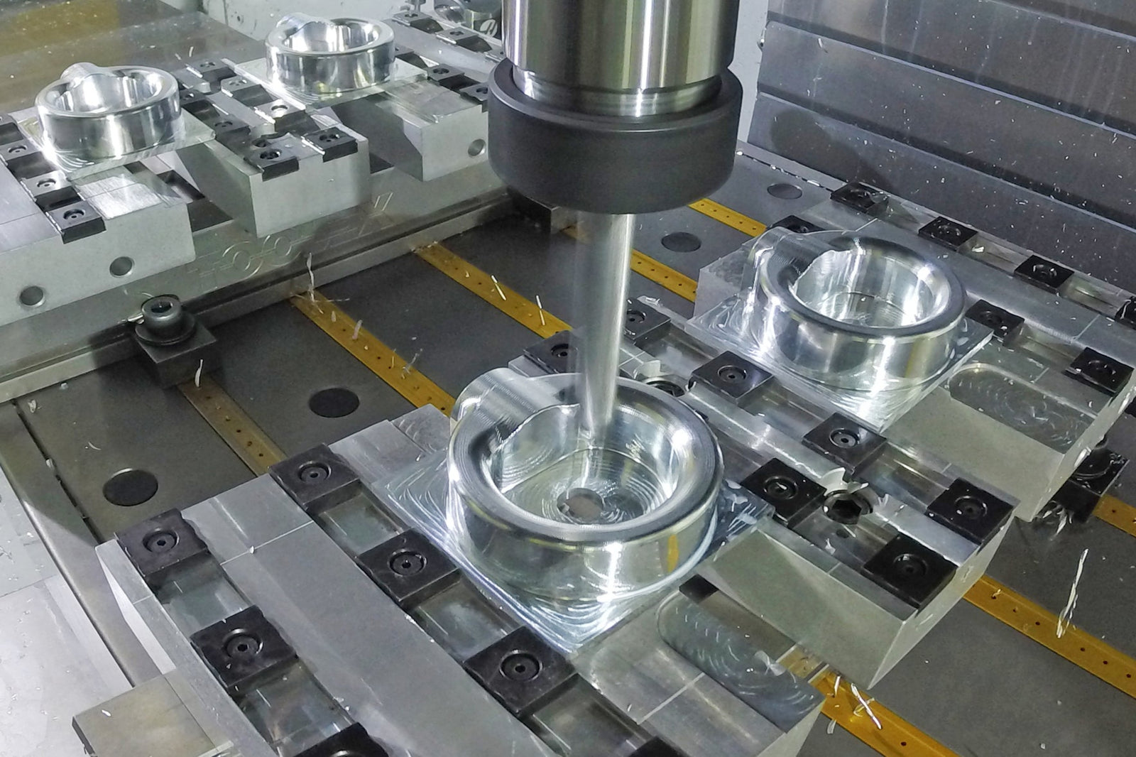 CNC machine tooling in action with metal components