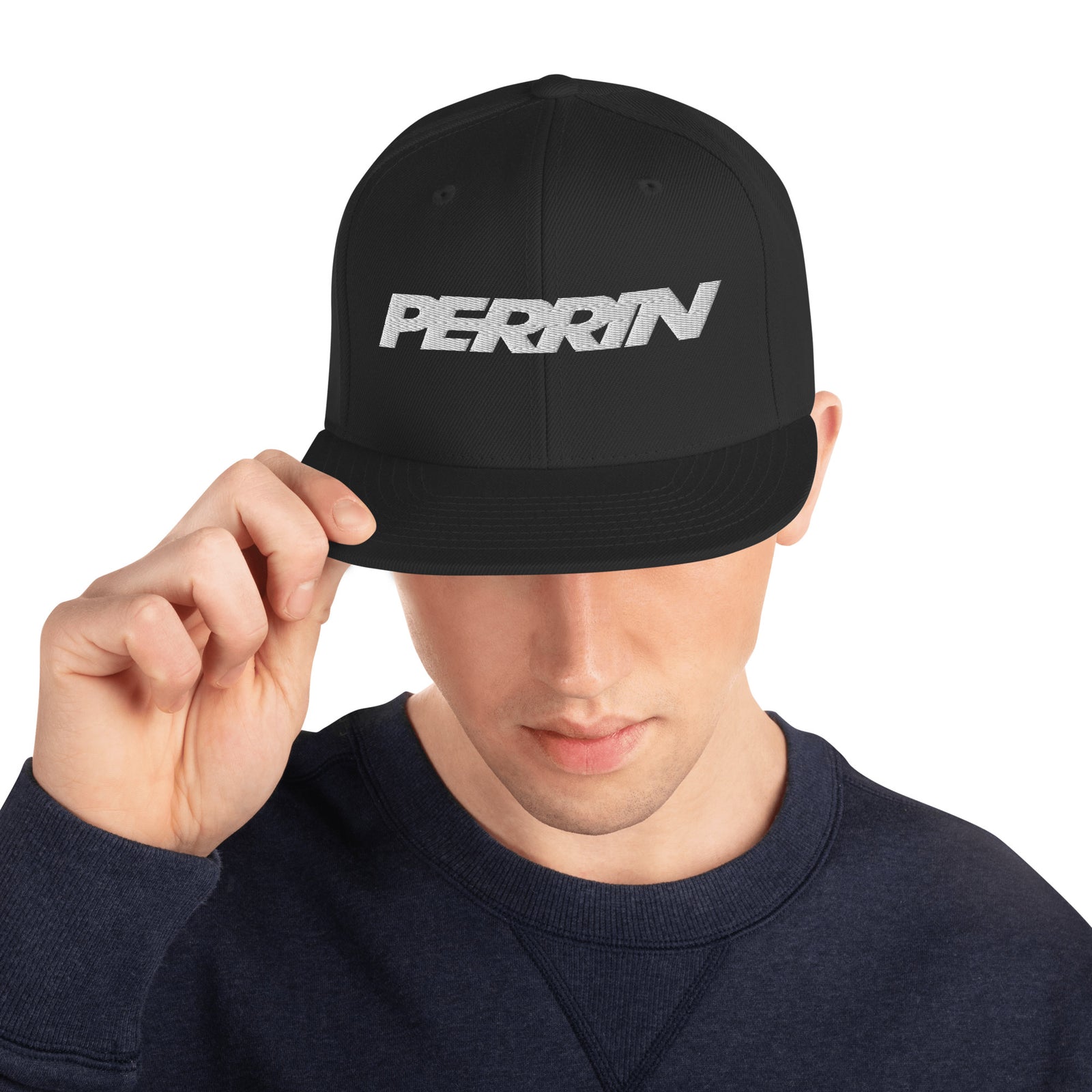 Black snapback hat featuring the PERRIN logo, perfect for automotive enthusiasts and casual wear.