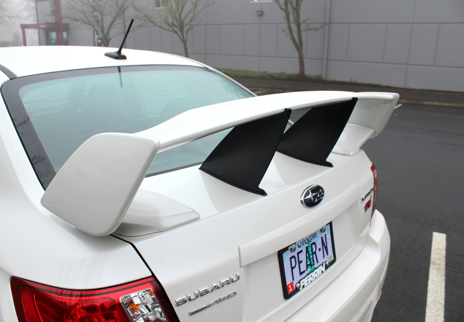 Wing stabilizer for 2011-2014 Subaru STI Sedan, enhancing aerodynamics and performance with a sleek design.