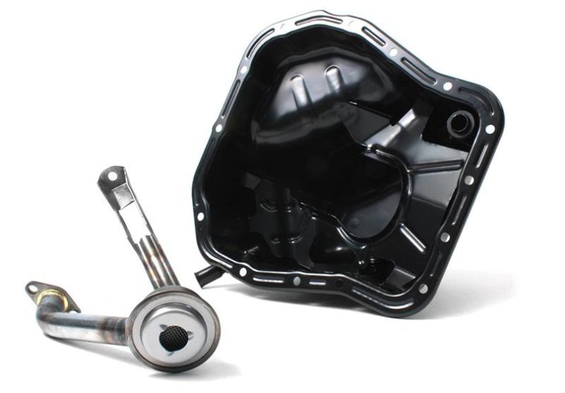 Header install kit for 2002-2005 WRX featuring a black metal header and a stainless steel exhaust pipe.