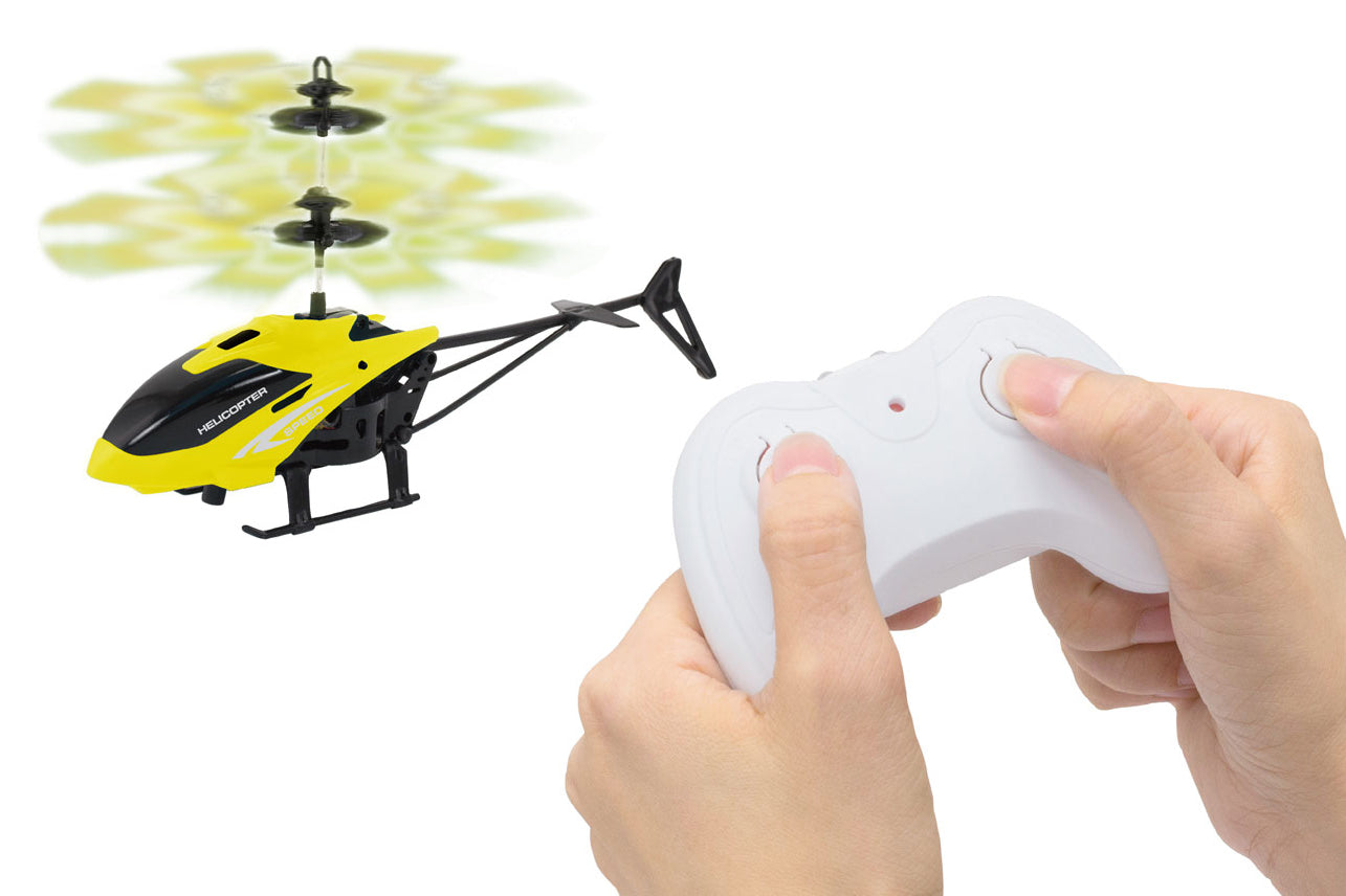 Yellow and black remote control helicopter with a white controller on a white background
