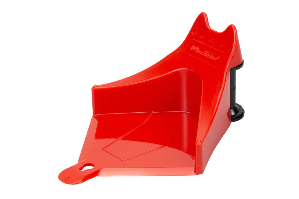 Red plastic tool with a black handle on a white background