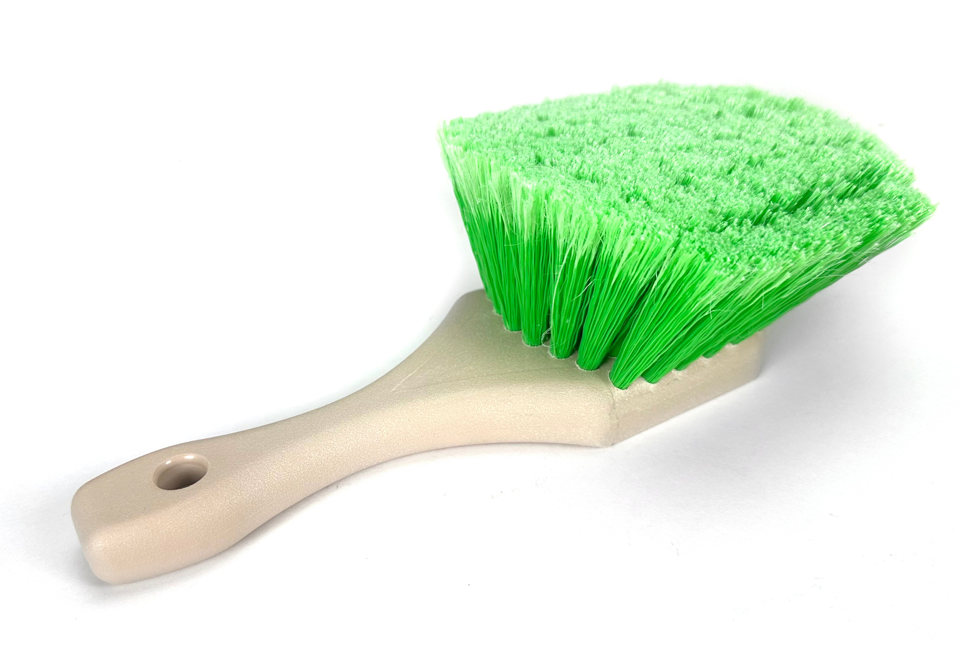 Green brush with a white handle on a white background