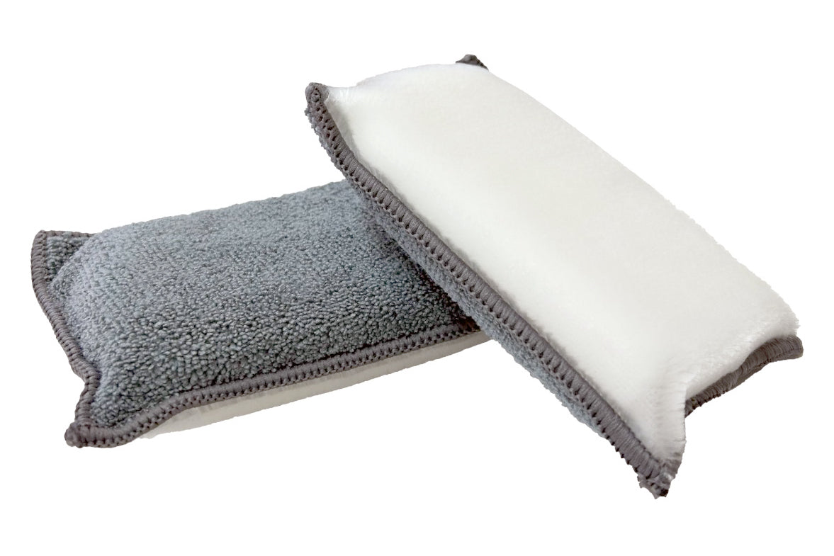 Two microfiber cleaning cloths, one gray and one white, on a white background.