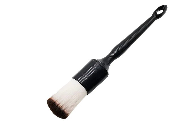 Detailing brush with black handle and white bristle head on a white background