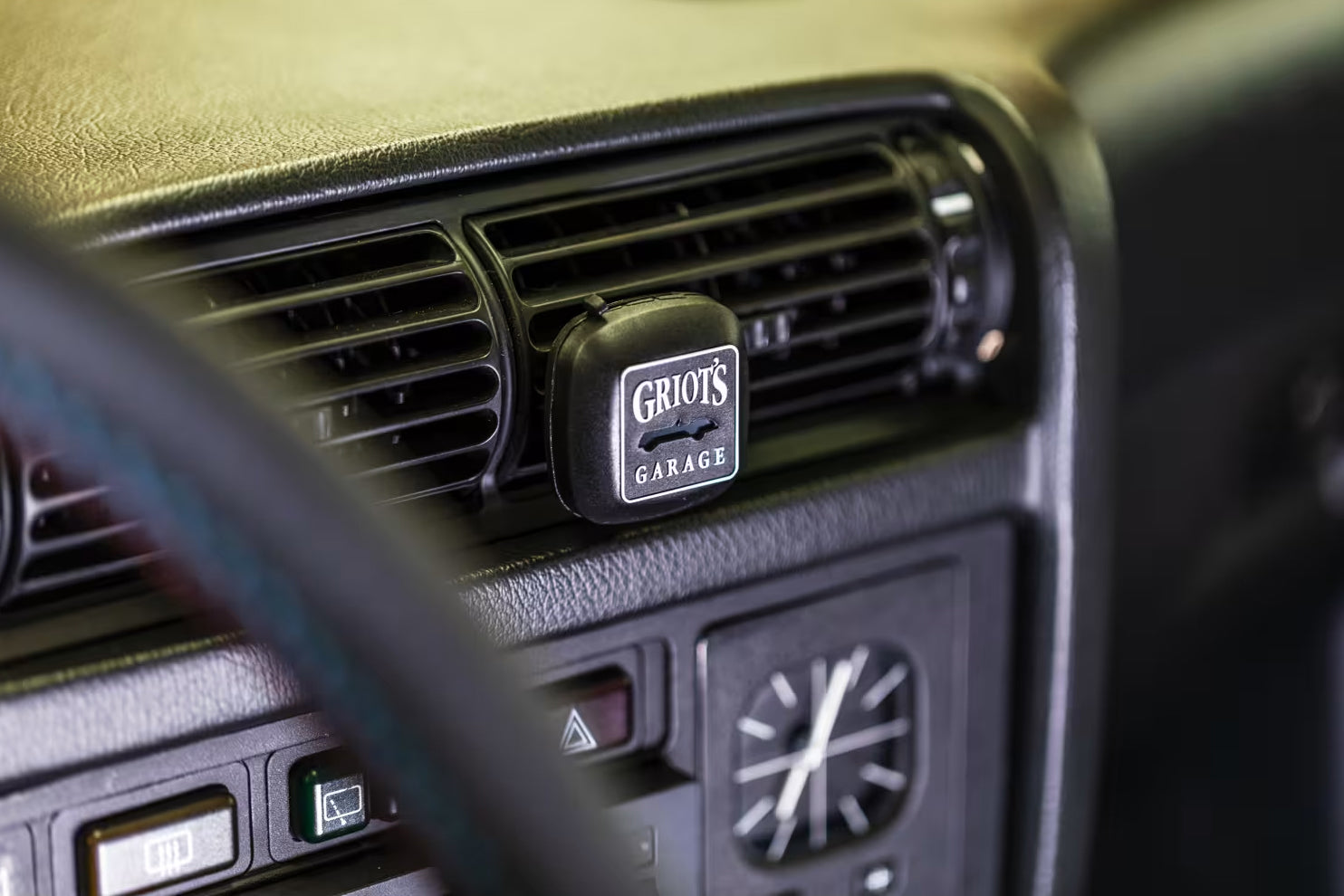 Car air vent with Griot's Garage logo on a vehicle interior.