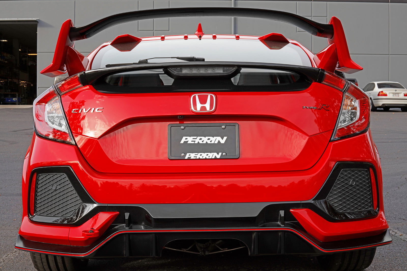 Rear view of a red 2017-2021 Honda Civic Type R showcasing a Perrin tow hook designed for performance and style.