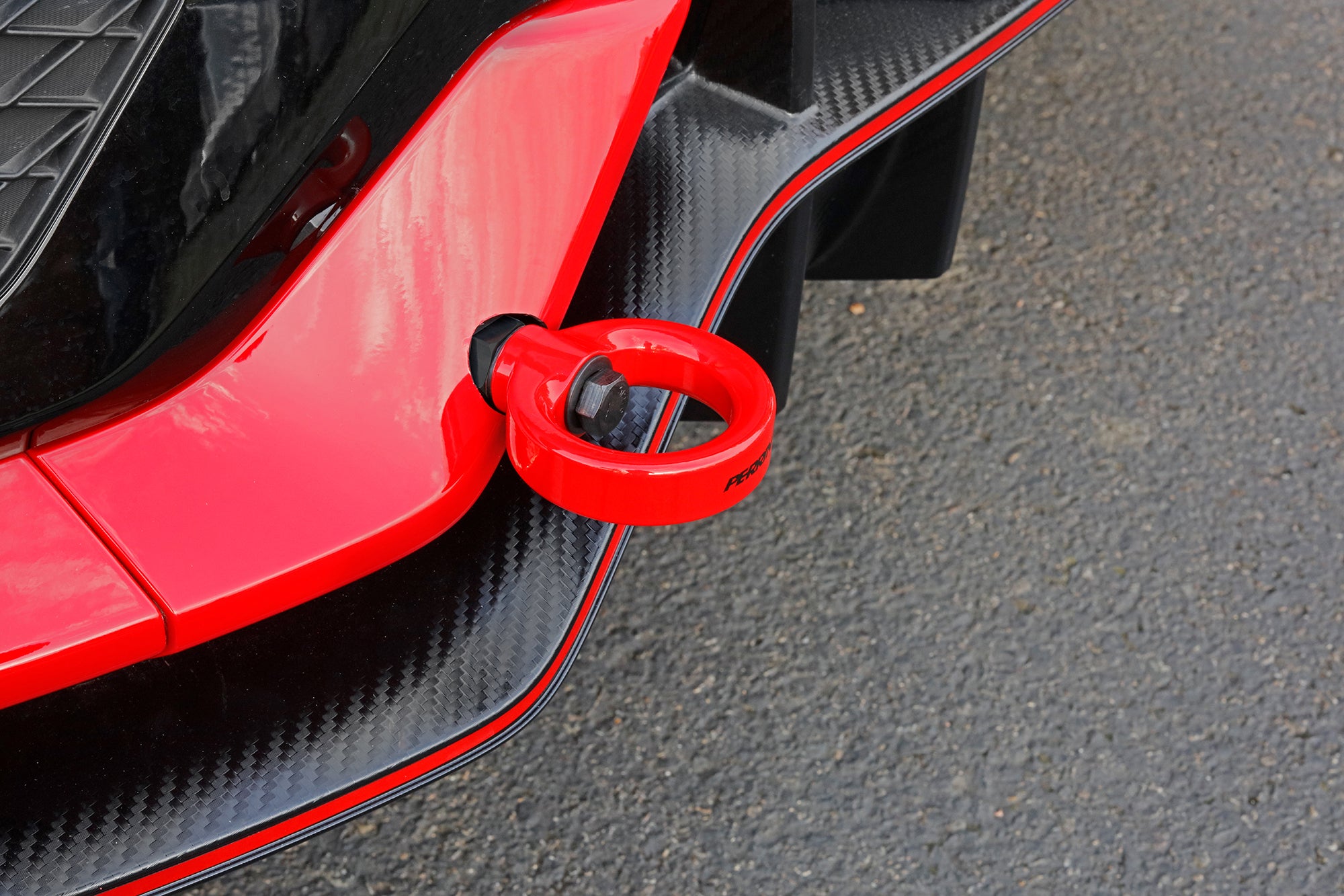 Red rear tow hook for 2017-2021 Civic SI and Civic Type R, designed for enhanced towing and sporty aesthetics.