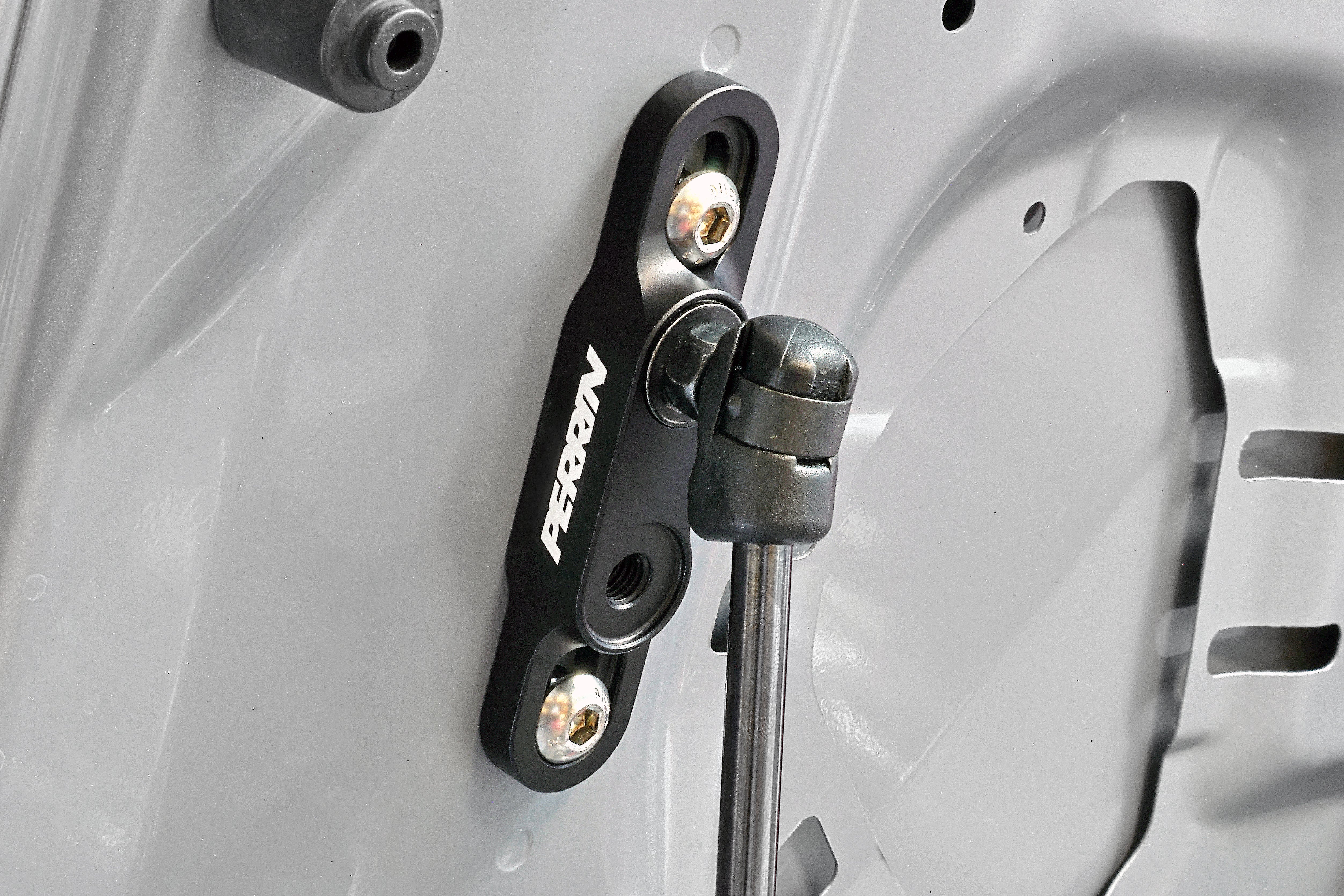 PERRIN High-Lift Hod Brackets installed on a Subaru.
