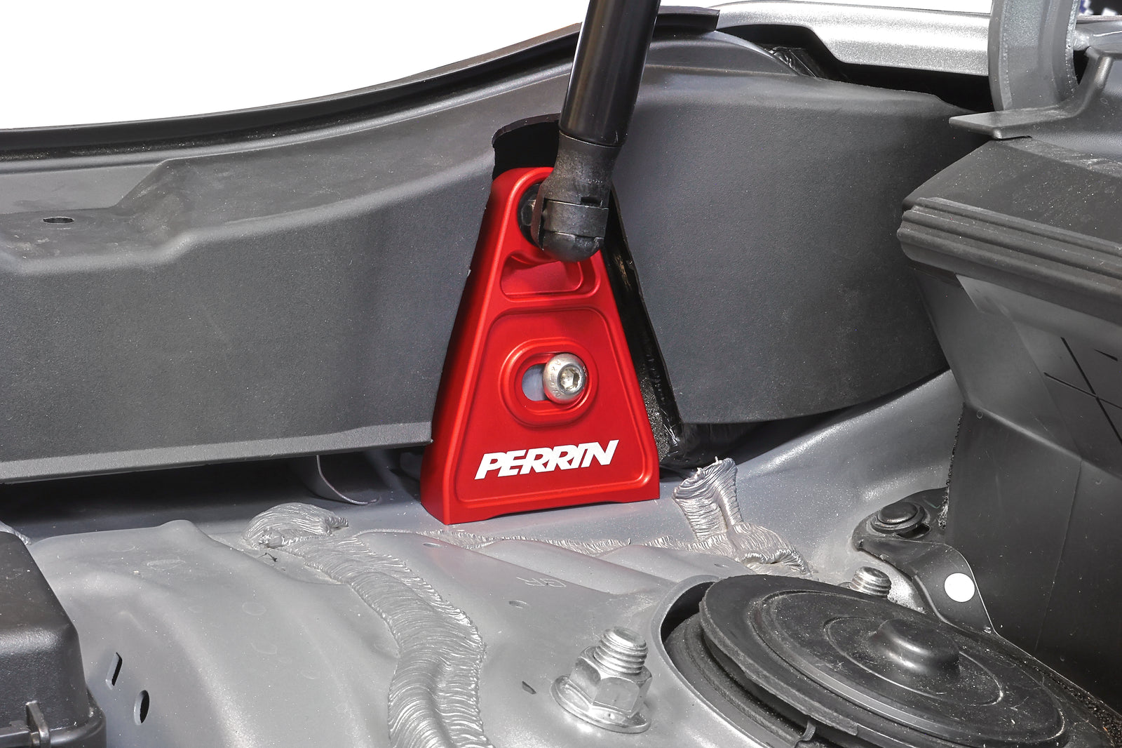 PERRIN High-Lift Hood Brackets installed on a Subaru.