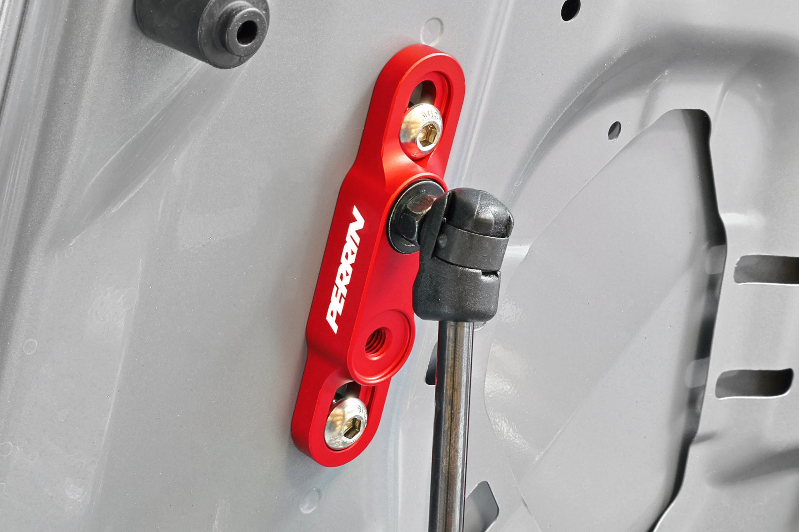 PERRIN High-Lift Hood Brackets Installed on a Subaru.
