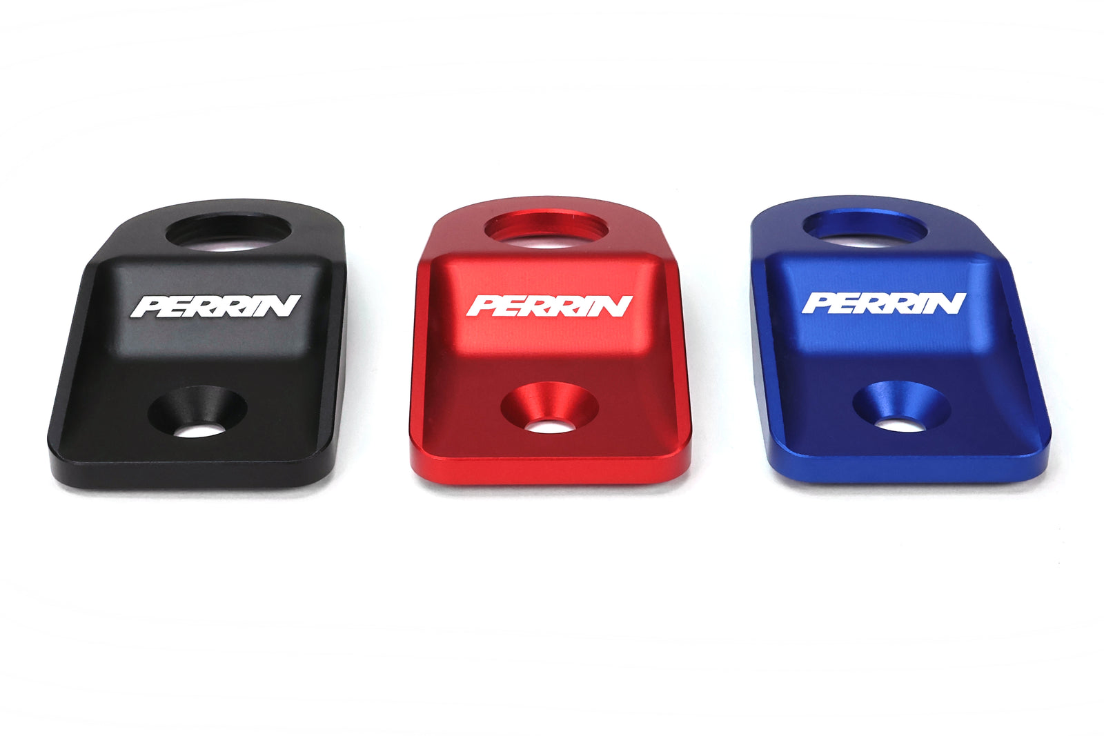 Perrin radiator stays for 2008-2014 WRX, STI, Impreza, and Outback in black, red, and blue finishes.