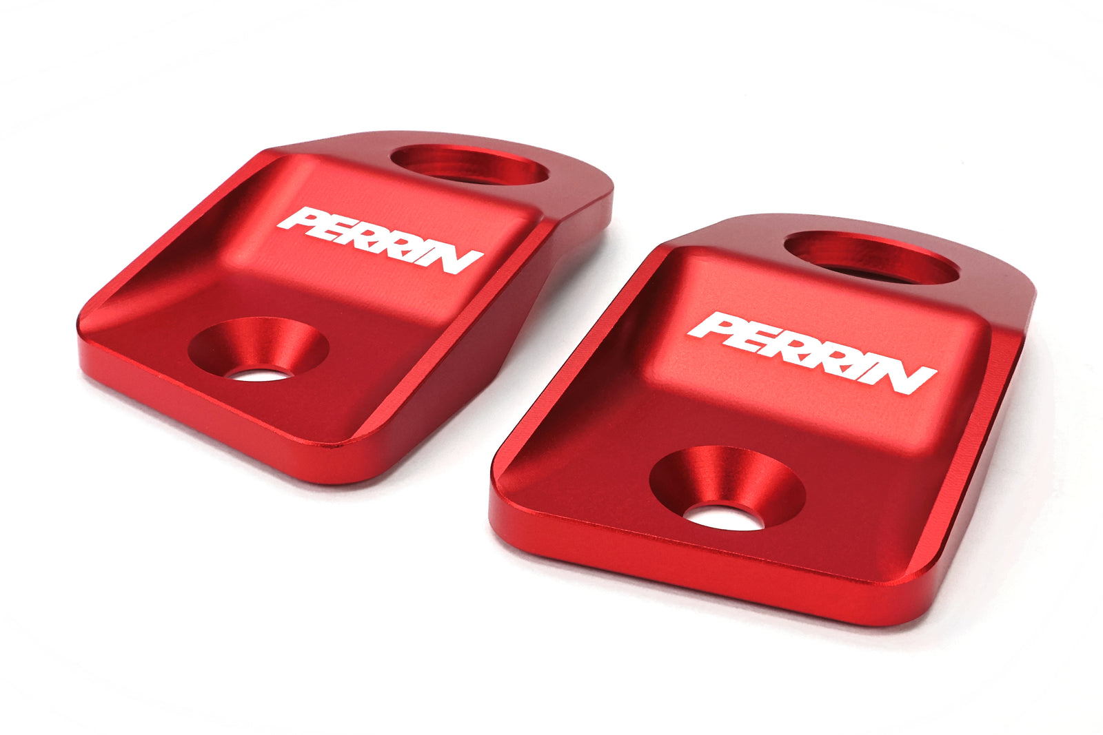 Perrin radiator stays for 2015-2021 WRX, STI, Impreza, and Crosstrek, featuring durable red aluminum construction.