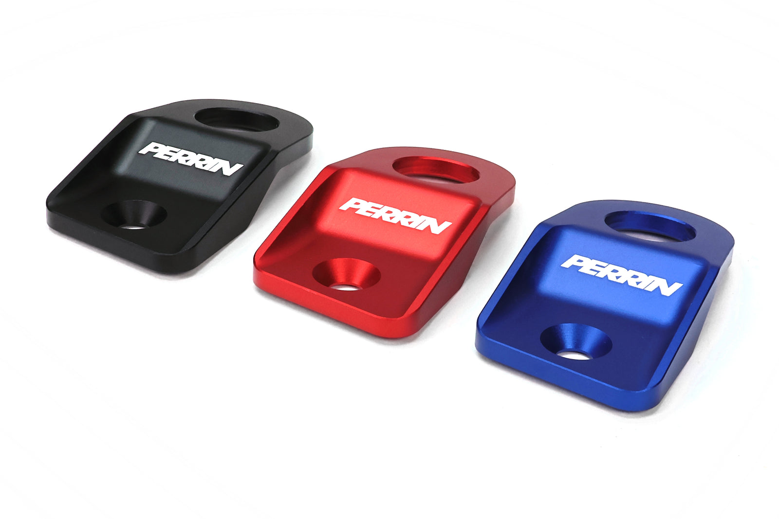 Perrin radiator stays for 2015-2021 WRX, STI, Impreza, and Crosstrek in black, red, and blue aluminum finishes.
