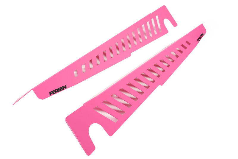 Bright pink Fender Shrouds with cut-out designs, featuring the Perrin logo, designed for automotive styling and protection.