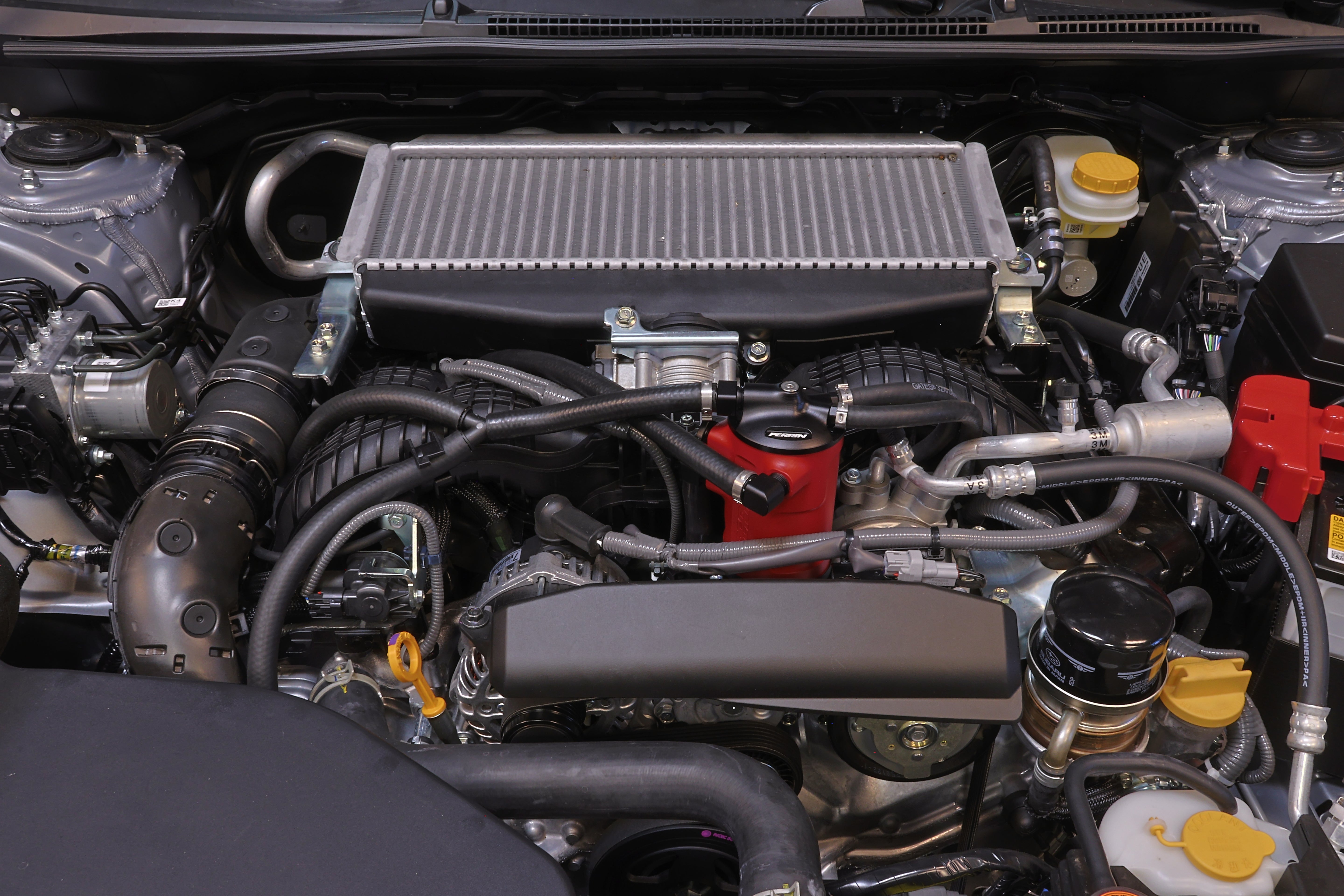 PERRIN red Air Oil Separator installed in 2022-2025 Subaru WRX engine bay.