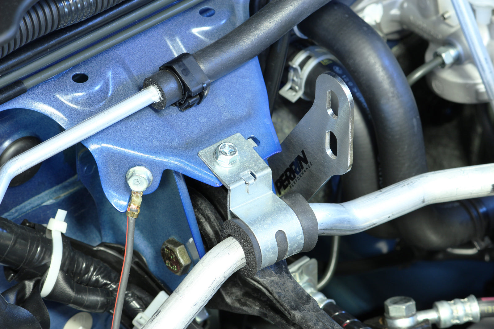 PERRIN Air Oil Separator FMIC mounting bracket installed on a 2002-2021 Subaru WRX/STI.