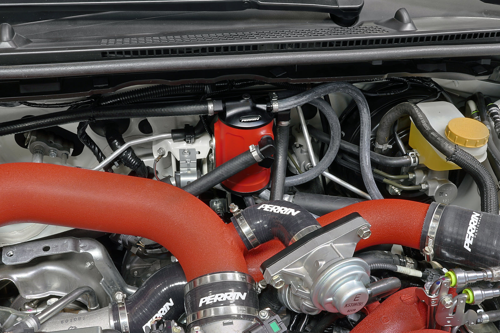 PERRIN Air Oil Separator FMIC mounting bracket installed on a 2002-2021 Subaru WRX/STI.