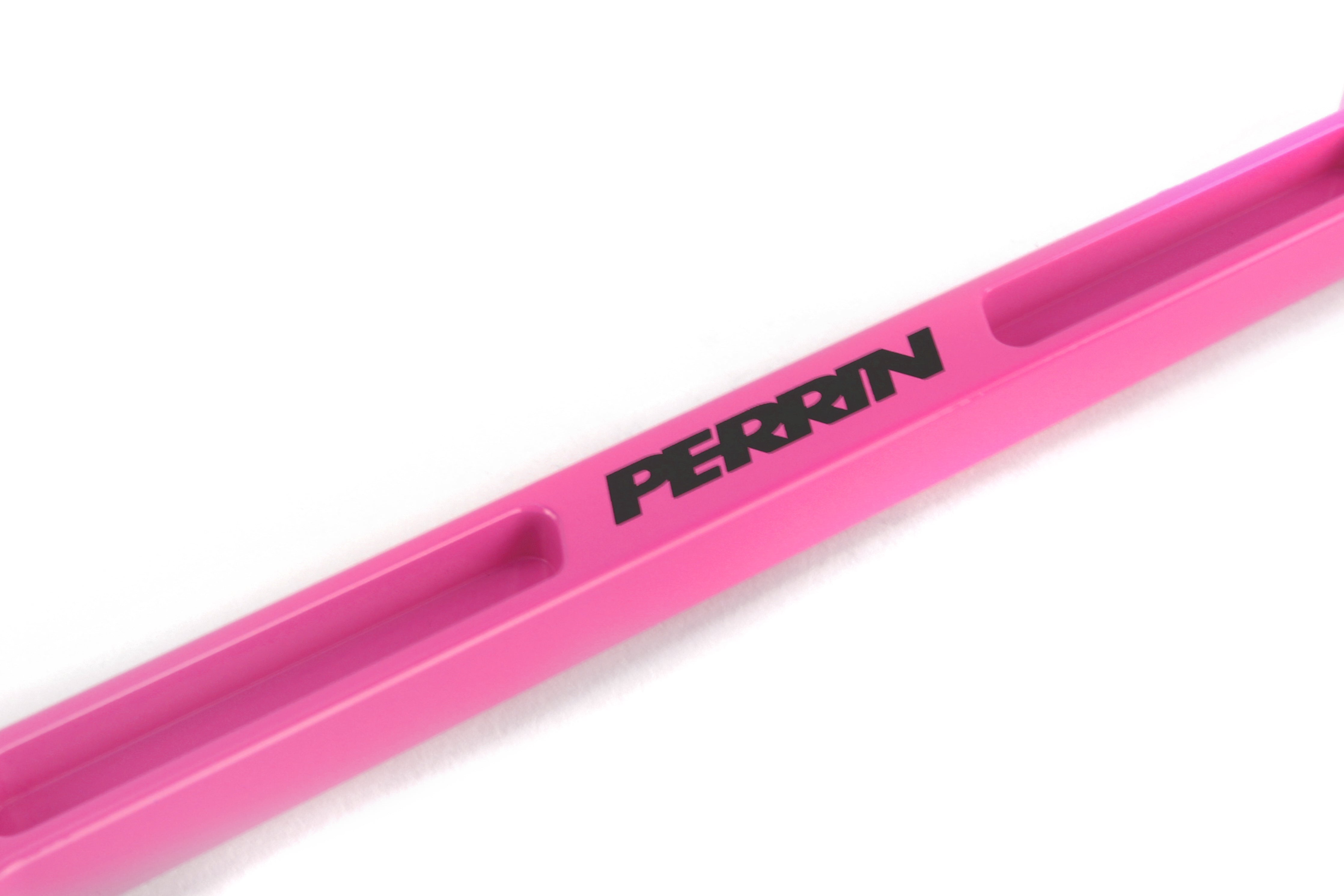 Perrin battery tie down in pink, designed for secure battery mounting in performance vehicles.