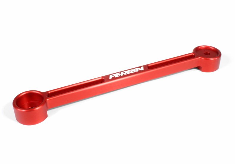 Red aluminum battery tie down with circular ends, featuring the Perrin logo, designed for secure battery installation.
