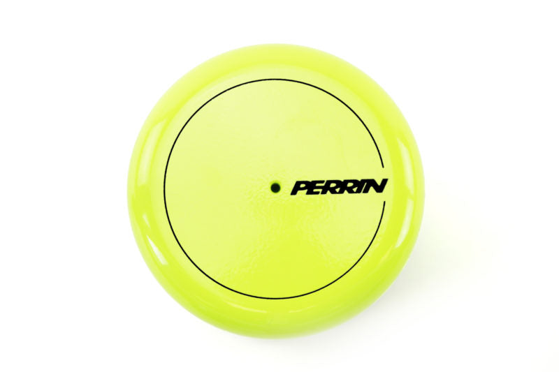 Bright yellow oil filter cover featuring the Perrin logo in black, designed for automotive applications.