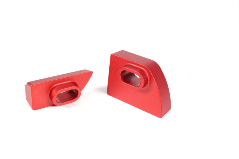 Red aluminum shifter stop upgrade components for WRX, featuring two distinct shapes for enhanced performance.