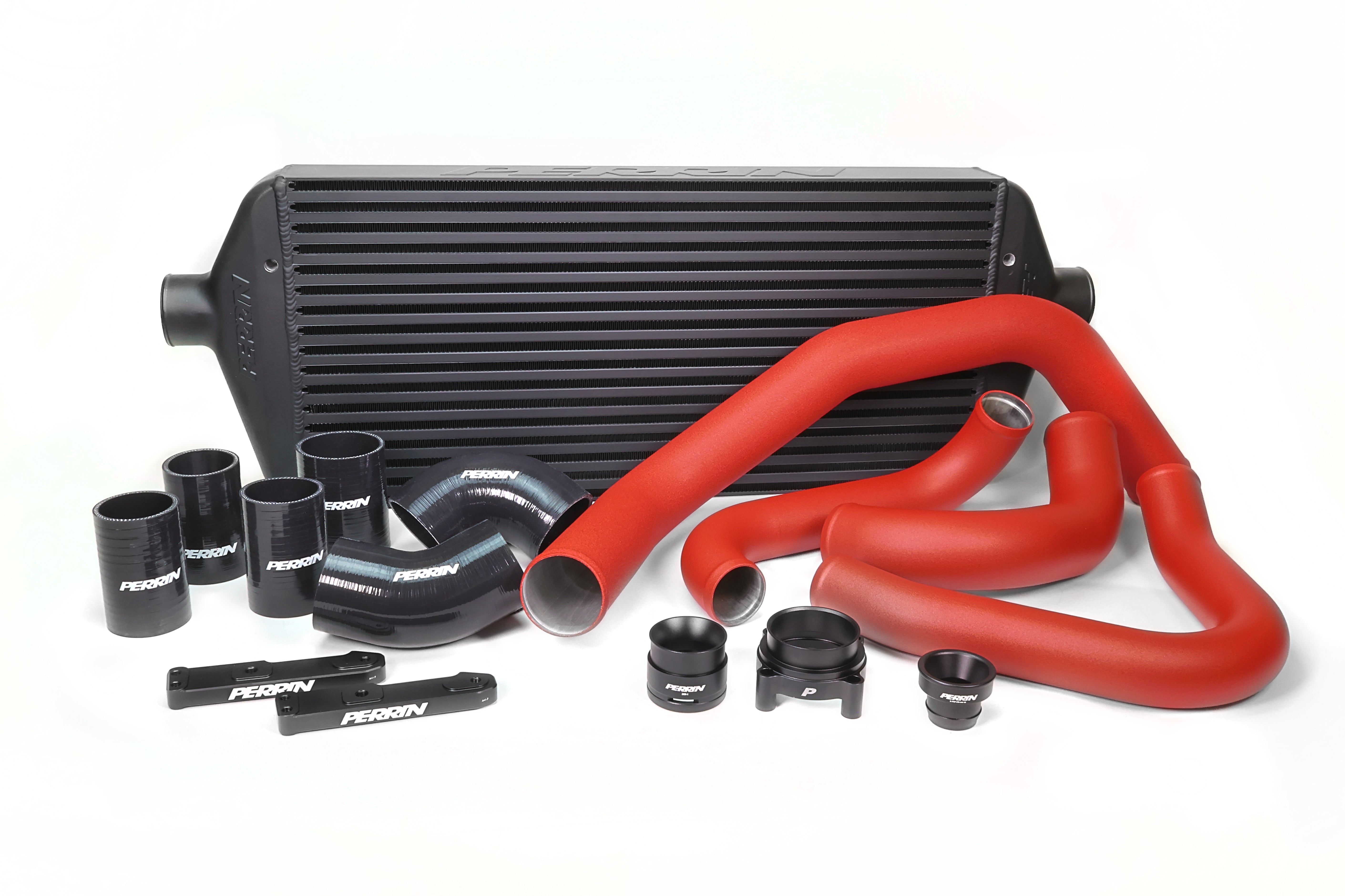 Front mount intercooler kit for 2022-2025 WRX, featuring red and black hoses, clamps, and a large intercooler.