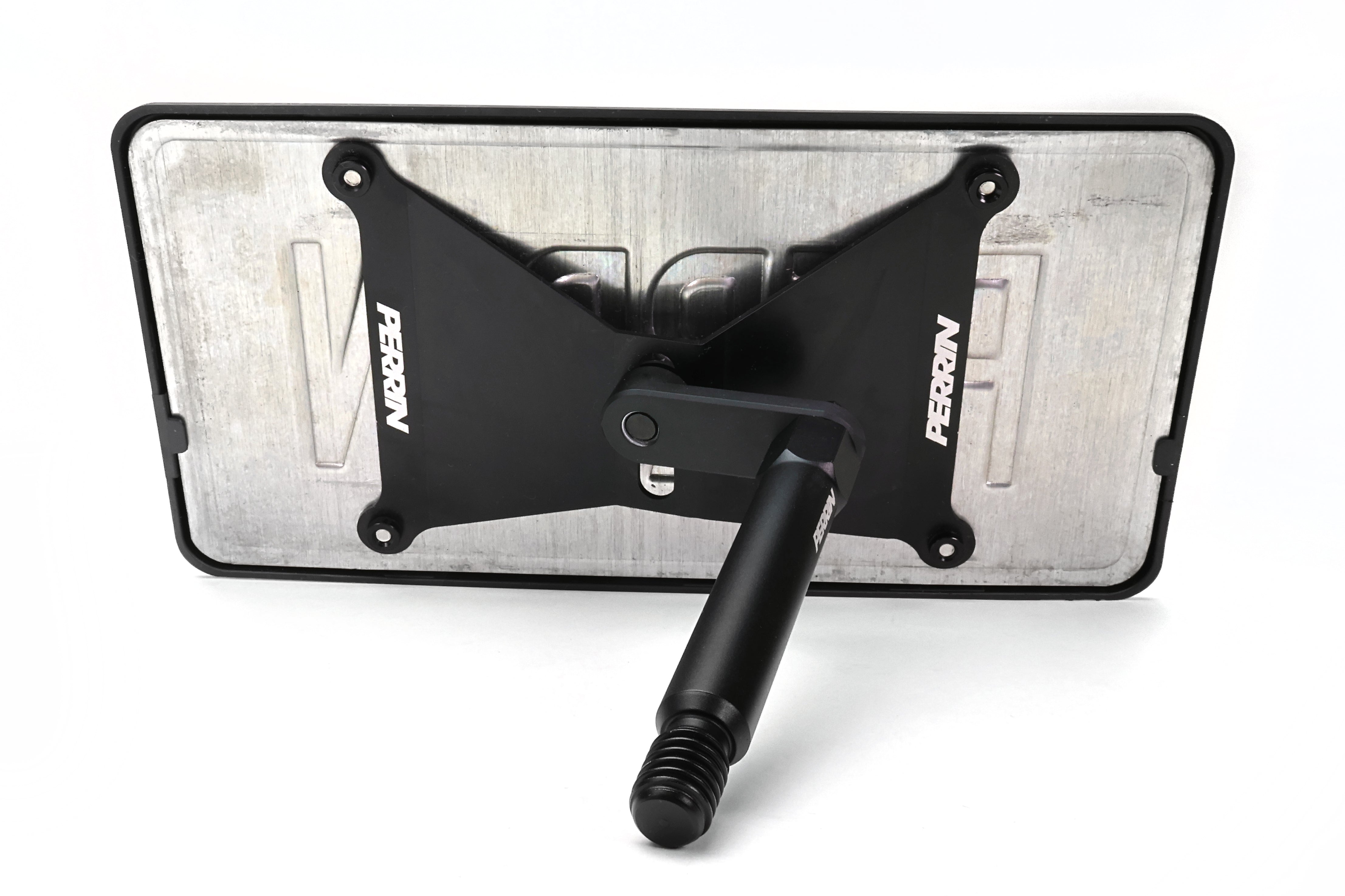 Close-up view of PERRIN license plate relocation hardware and mounting components for GR Corolla installation.