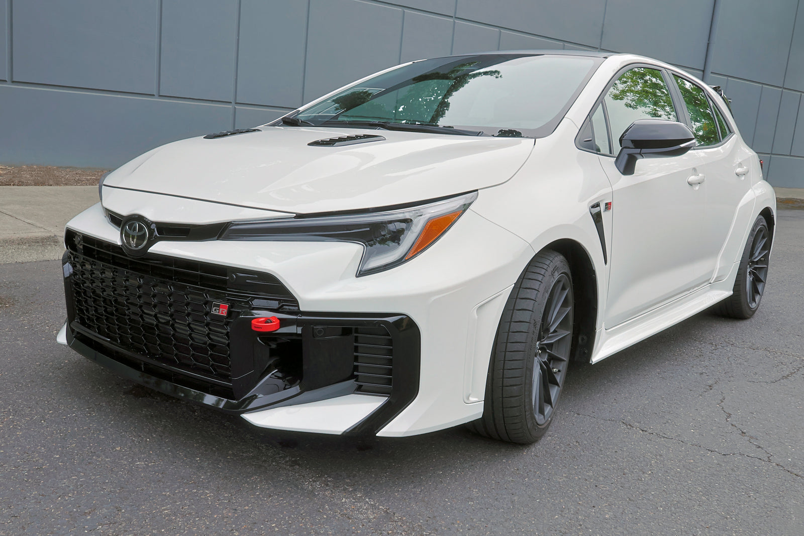 Close-up of PERRIN tow hook mounted on GR Corolla showing red anodized finish and fitment.