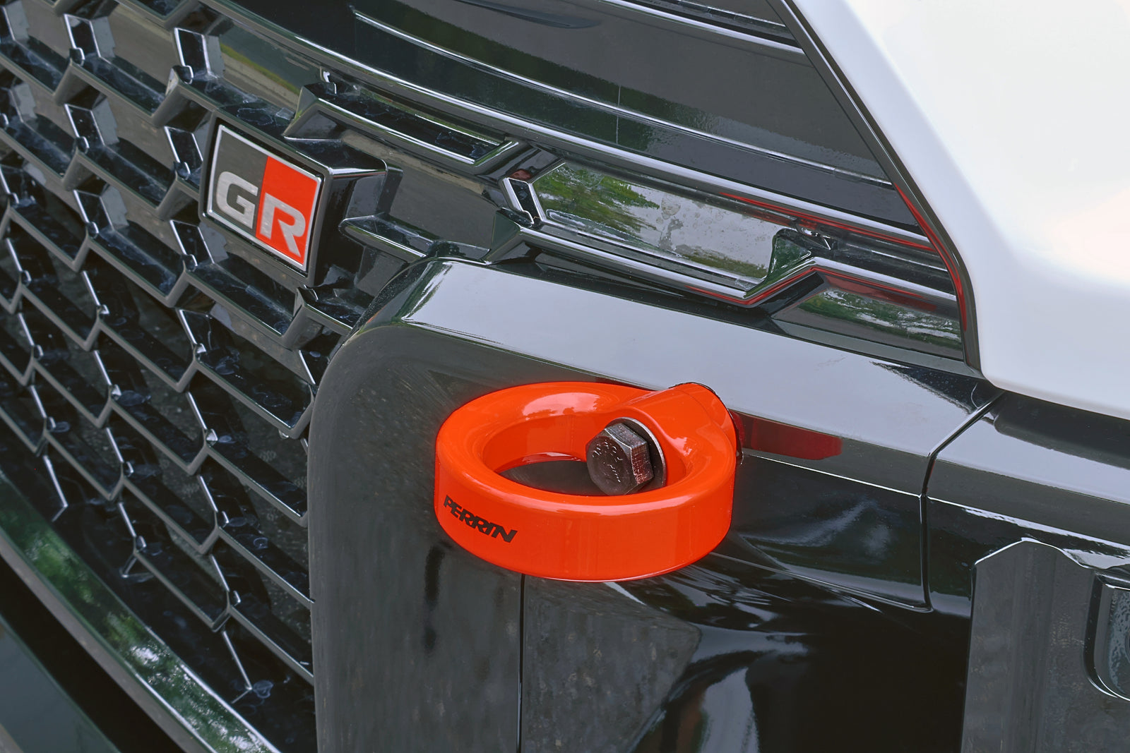 Side angle view of PERRIN front tow hook installation on 2023-2026 GR Corolla.