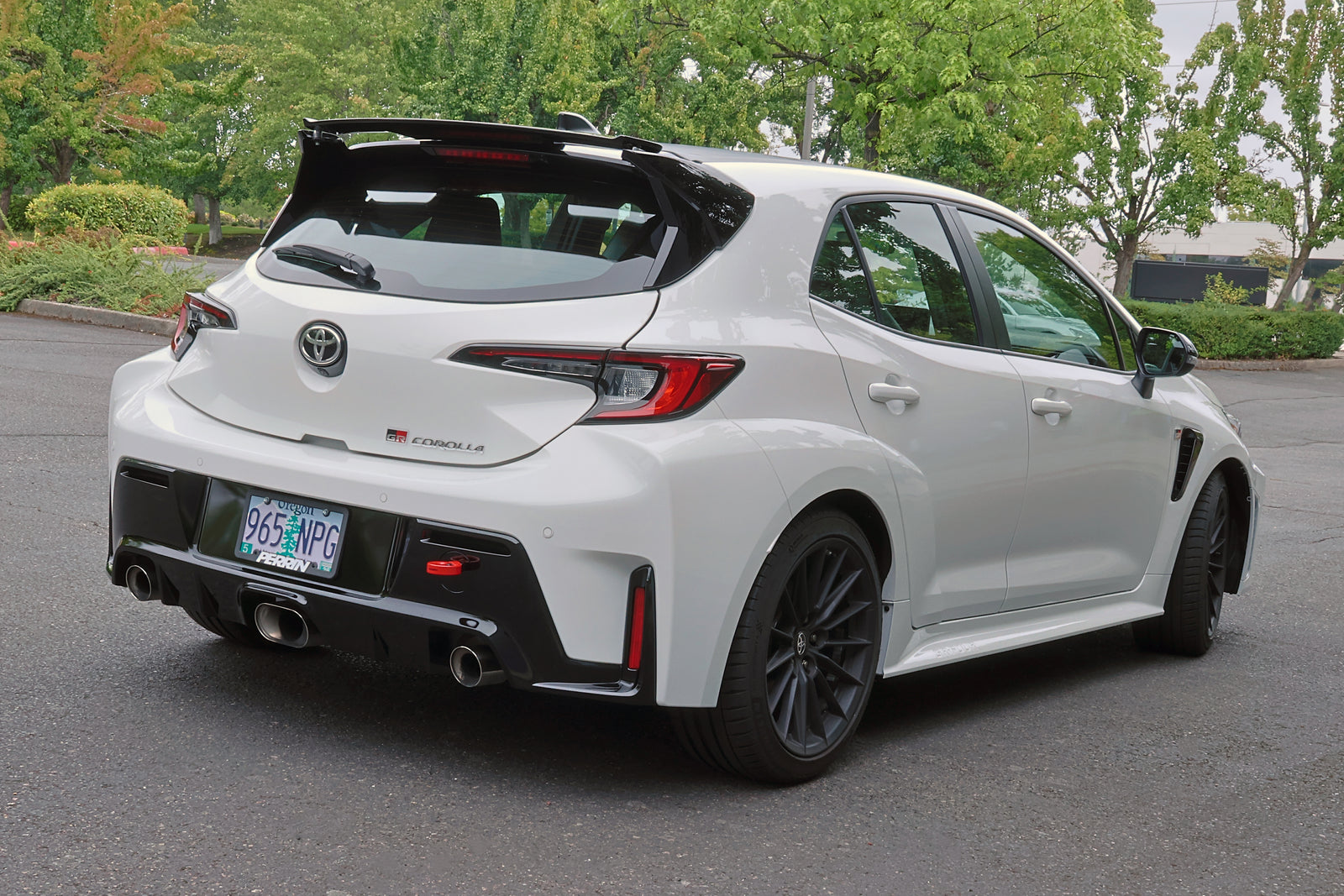 PERRIN red rear tow hook installed on 2023-2026 Toyota GR Corolla rear bumper.