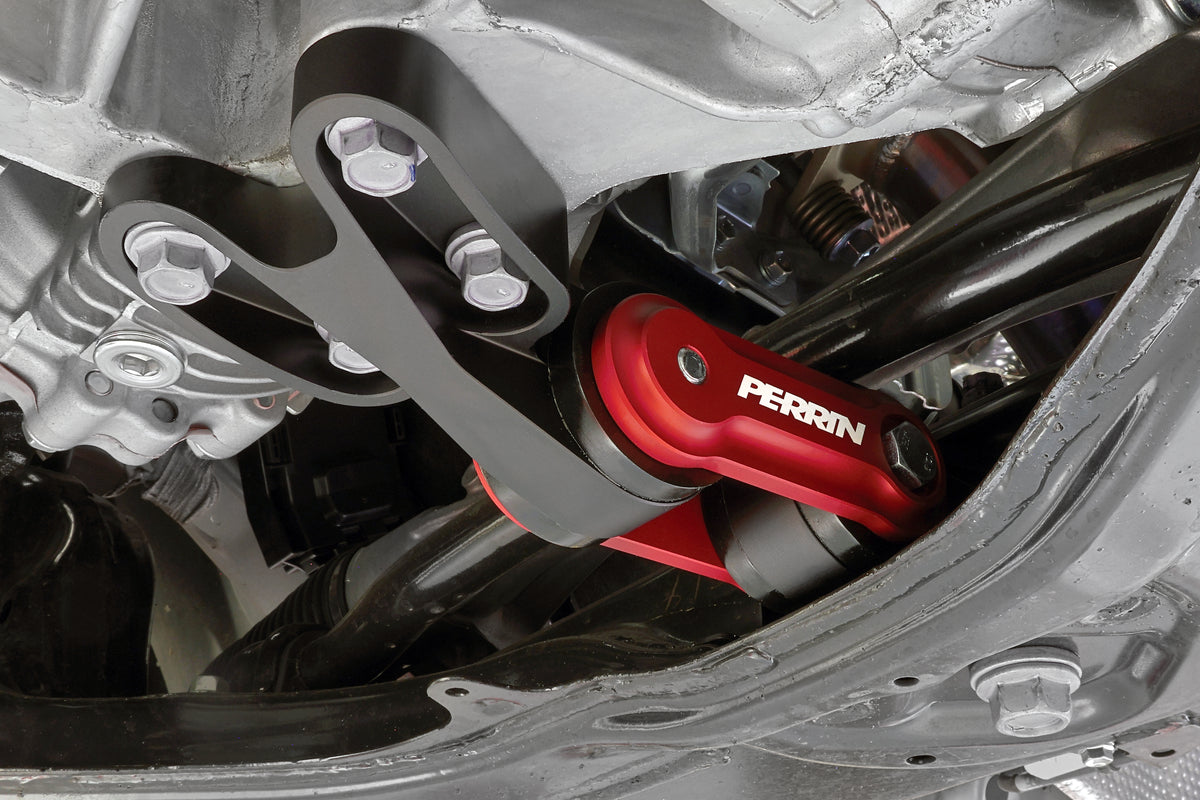 PERRIN Pitch Stop Mount installed on GR Corolla, bolted to aluminum housing with white PERRIN logo visible