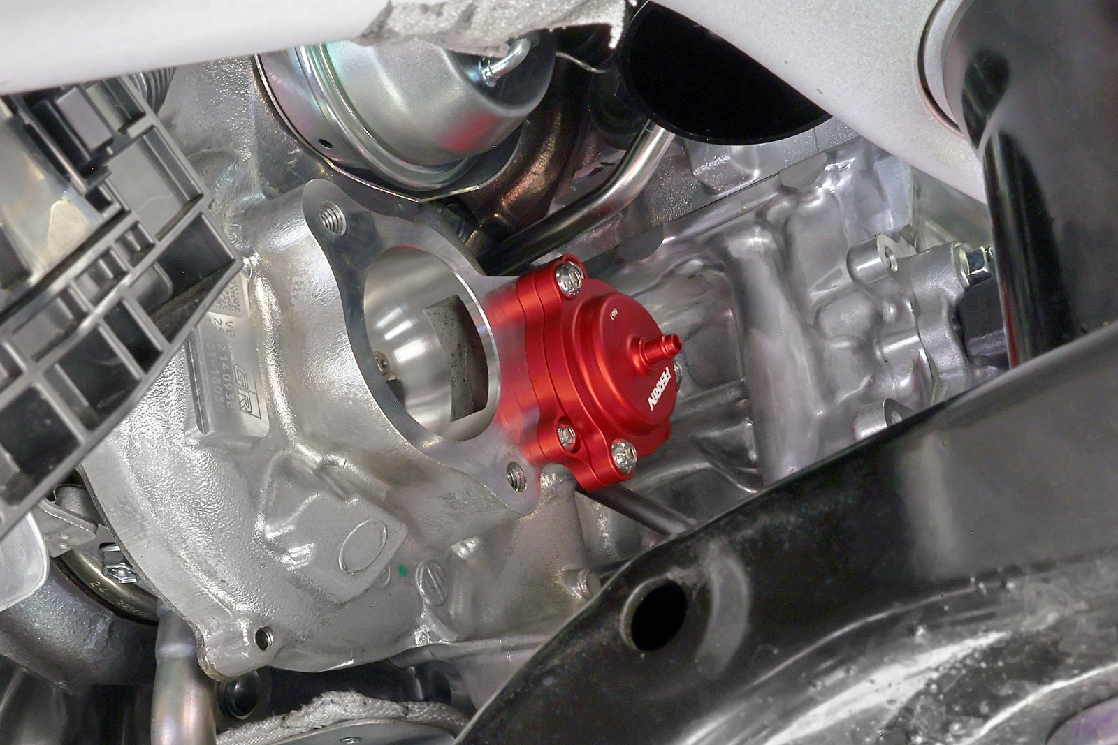 PERRIN GR Corolla Diverter Valve mounted to turbocharger, close-up install shot in engine bay
