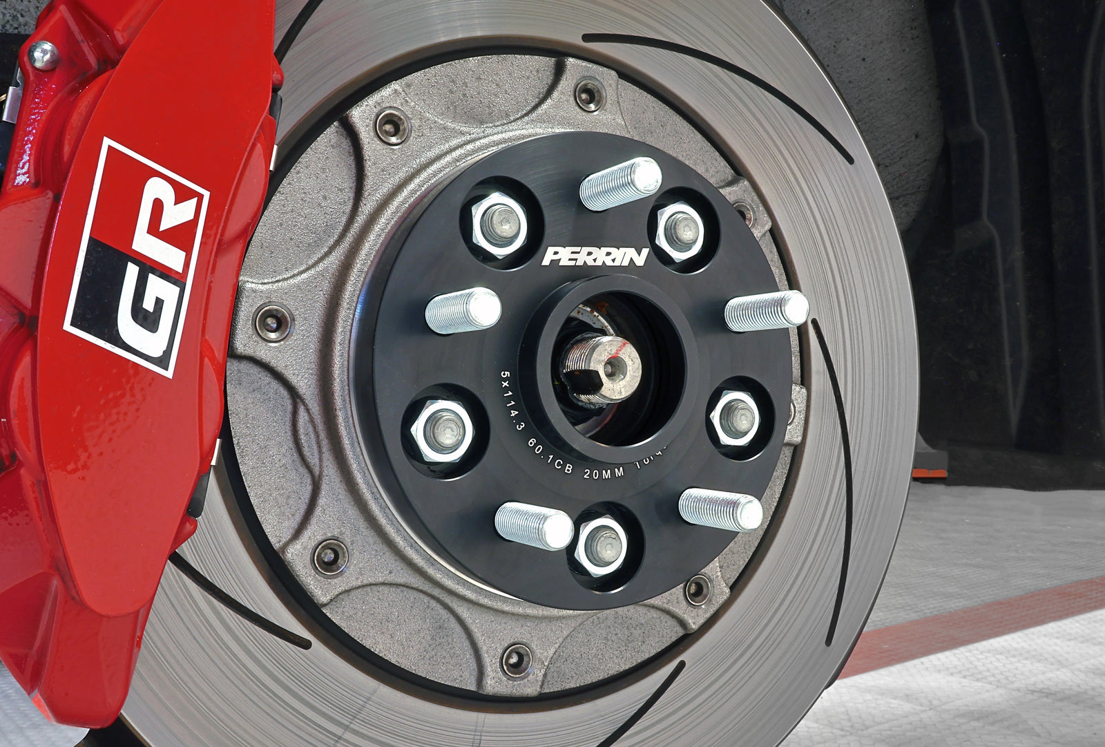 A set of PERRIN 20mm Wheel Spacers installed on a 2023-2026 Toyota GR Corolla.