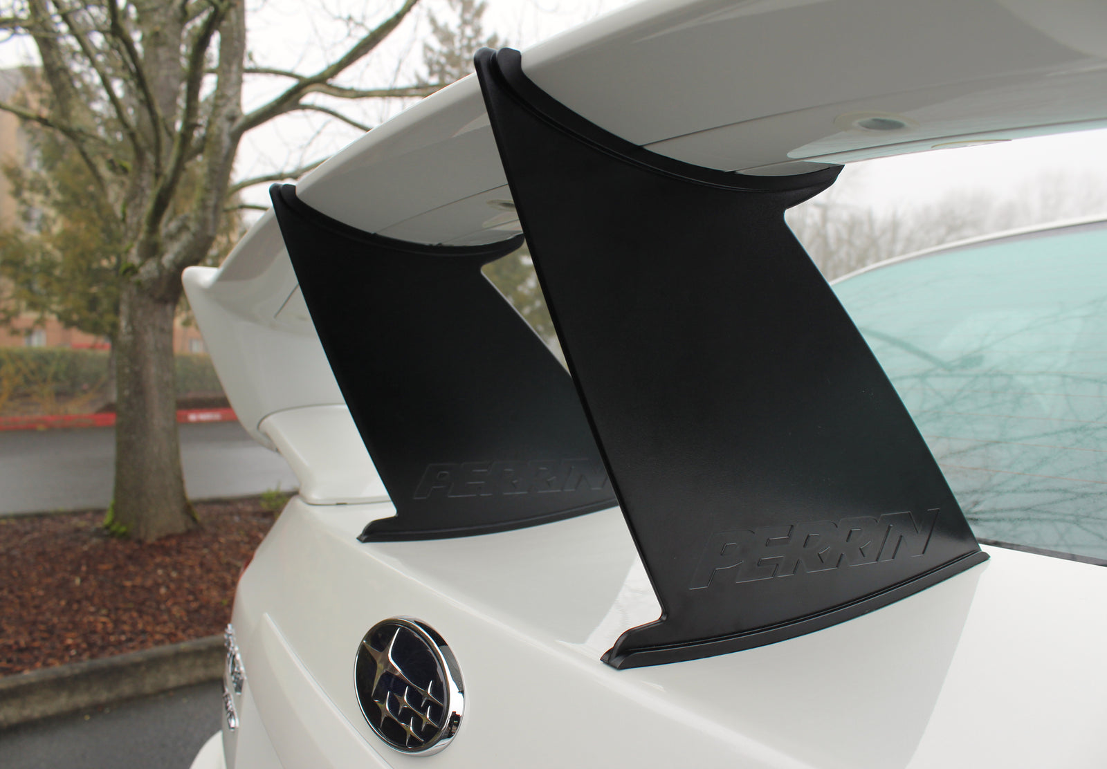 Perrin wing stabilizer for 2011-2014 STI Sedan enhancing aerodynamic performance and stability.