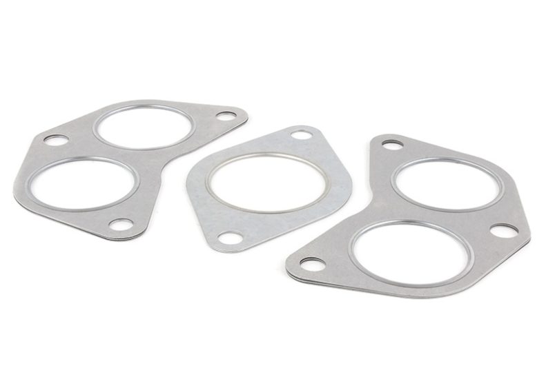 Header gasket kit for EJ engines featuring three metal gaskets with circular cutouts for secure sealing.